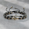Pulsera apilable de hematita con decoración de cruz (2 piezas)