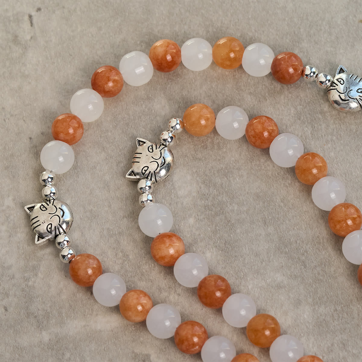 Pulsera de Cuarzo Naranja y Blanco con Caras de Gato, Rosario Animal de Acero Inoxidable