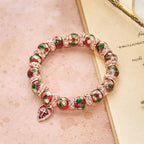 Pulsera de cuentas rojas de esmalte con colgante de corazón cruzado