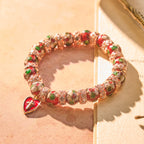Pulsera de cuentas rojas de esmalte con colgante de corazón cruzado