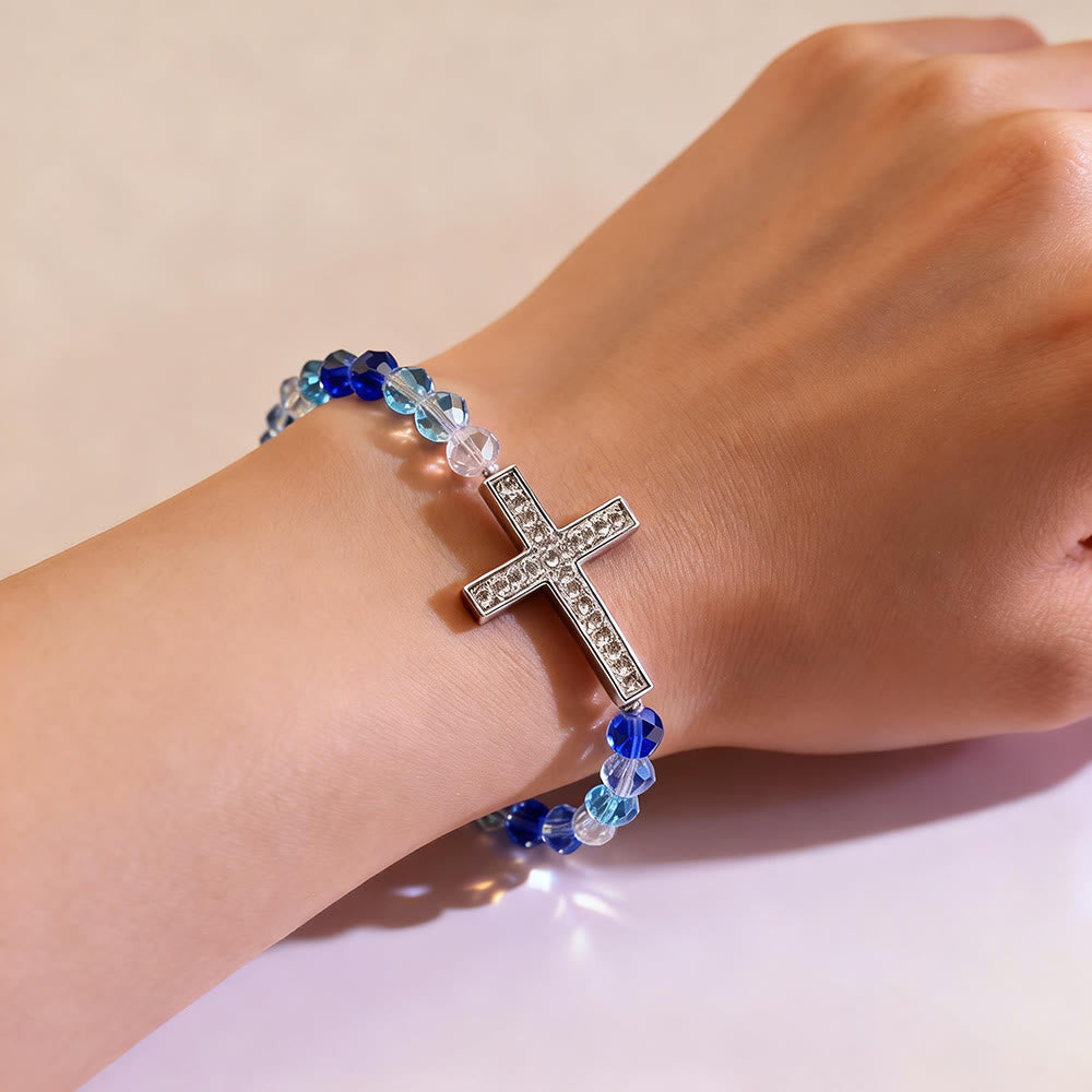 Pulsera Cruz Blanca y Azul Pavo Real: Creencia Envuelta en Brillo